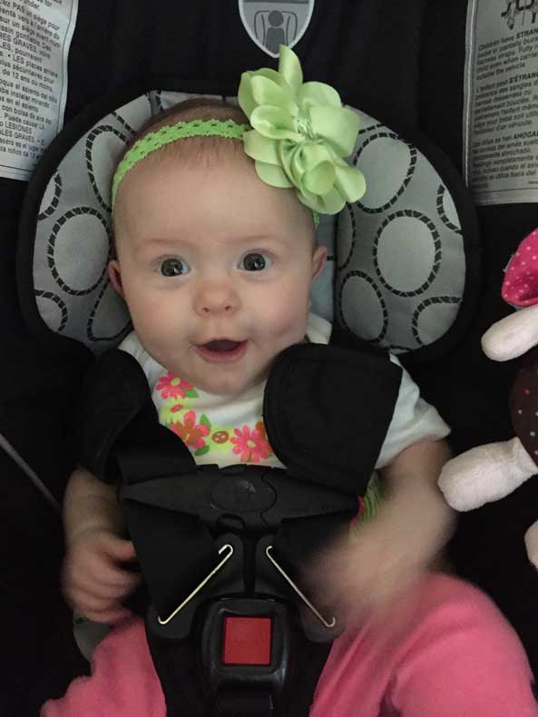 Infant in a car seat on a Road trip with a newborn