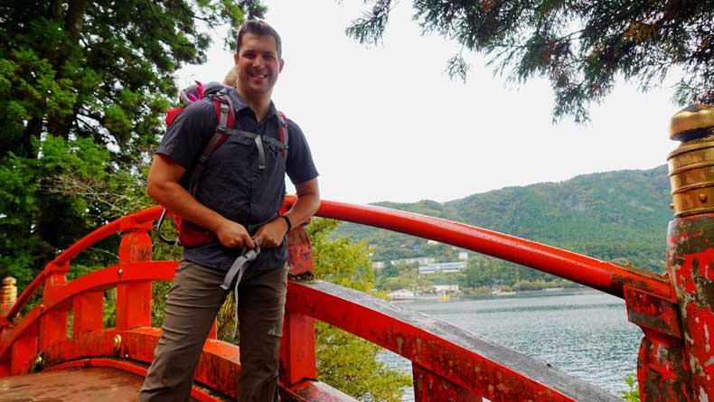 A man on a bridge along the Lake Ashi hiking trails near Hakone-Japan