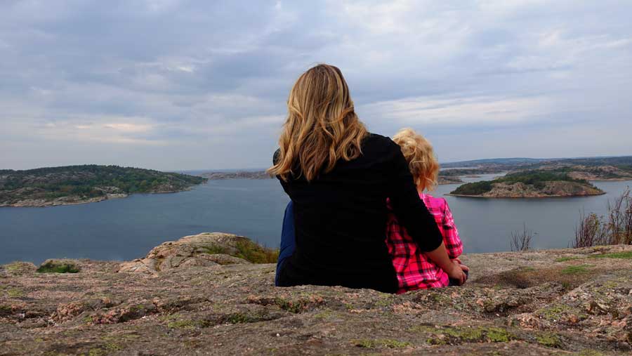 Me and my daughter sitting on a rock looking out at the Weather islands Sweden west coast