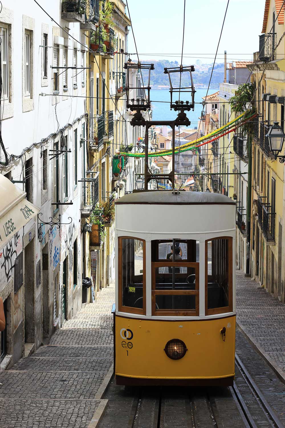 A tram going up a steep street in Lisbon