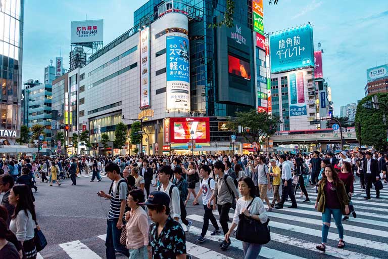 people crossing the street in the shibuya crossing