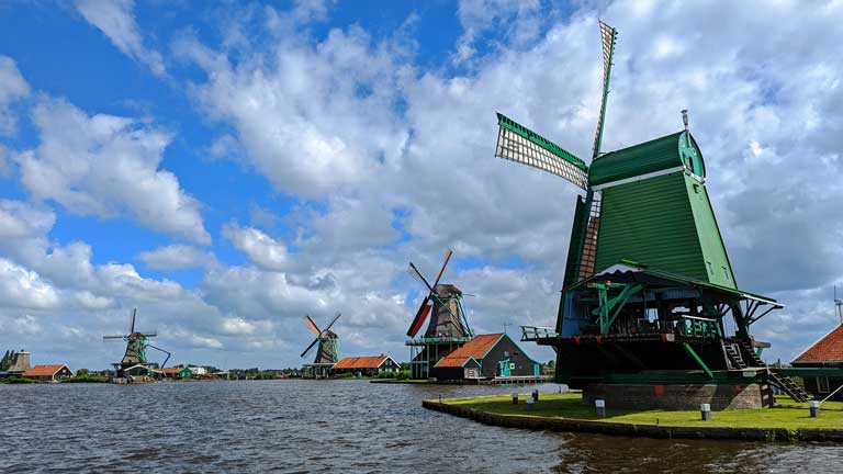 Windmills along the waterfront in Zaanse Schans - an easy day trip from Amsterdam.