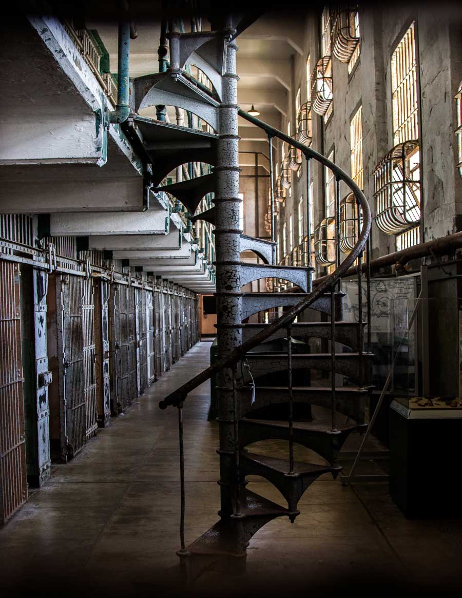 A spiral staircase and prison cells inside a prison block in Alcatraz