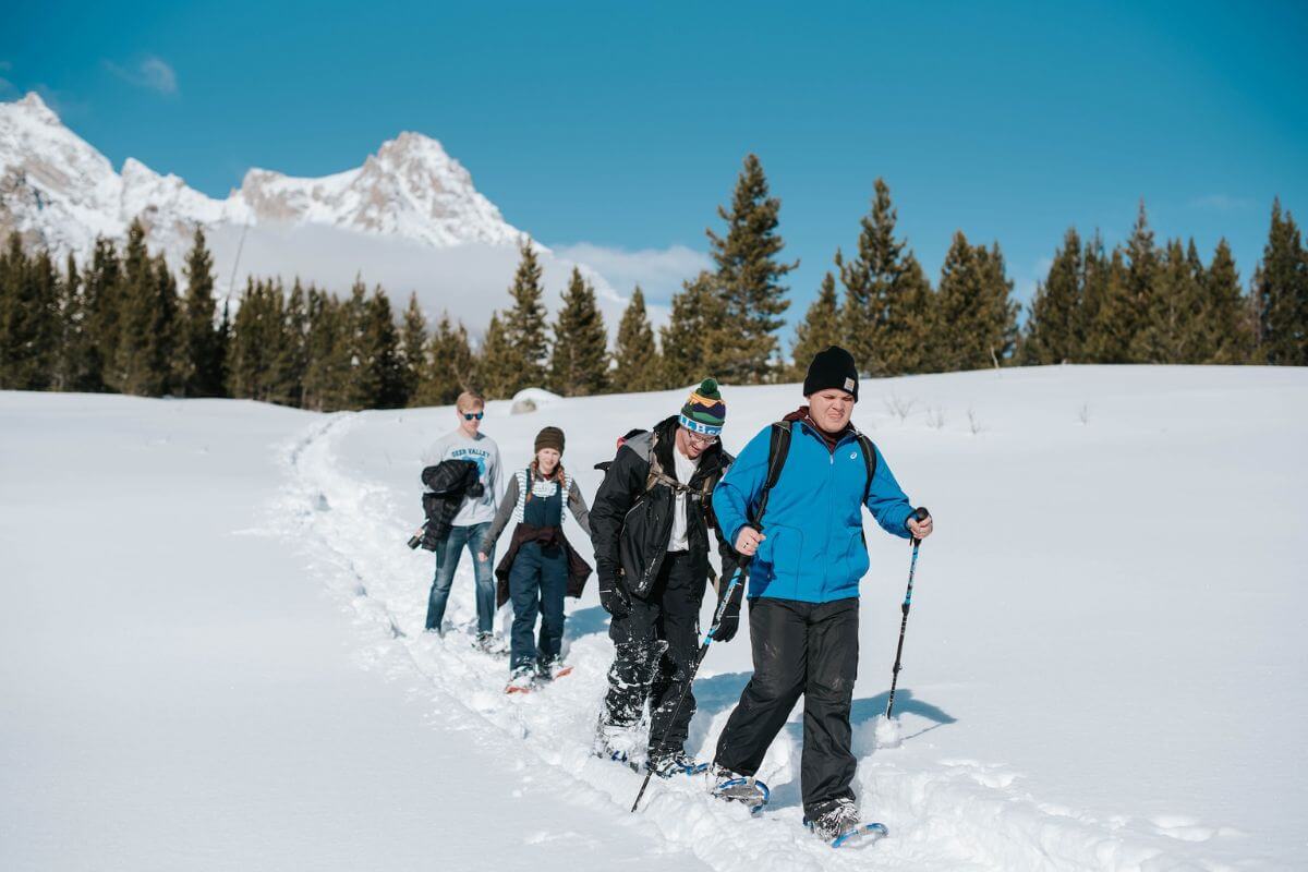 teenage kids snowshoeing