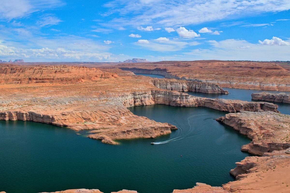 a boat in lake powell surrounded by cliffs