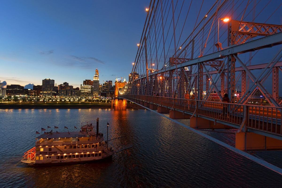 a riverboat on the Ohio River at sunset with Cincinnati in the background