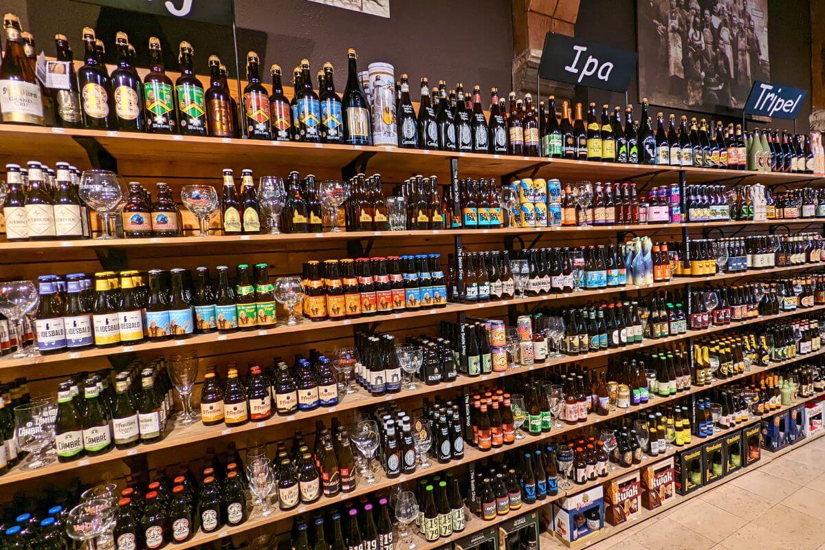 belgian beers and corresponding glasses at a beer store in Bruges Belgium