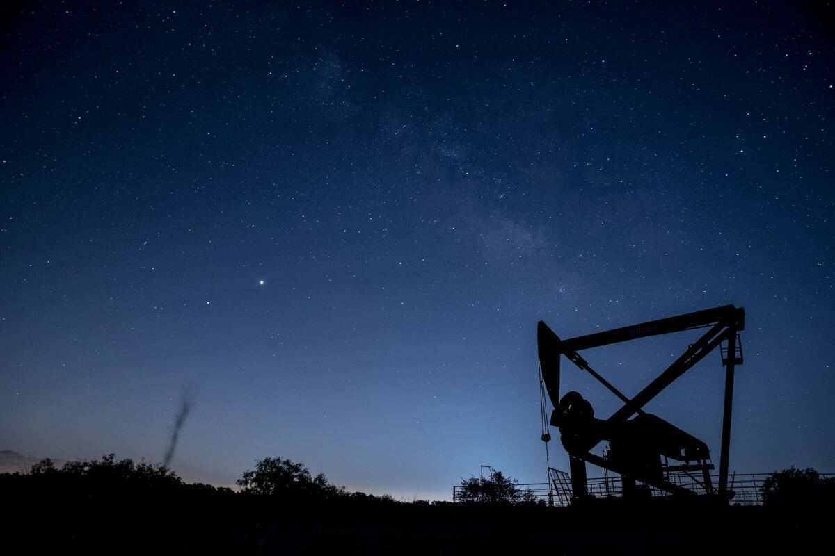 a pumpjack against the backdrop of a starlit sky