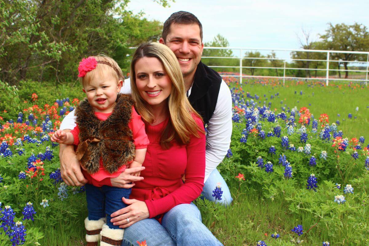 our family taking a photo surrounded by bluebonnets