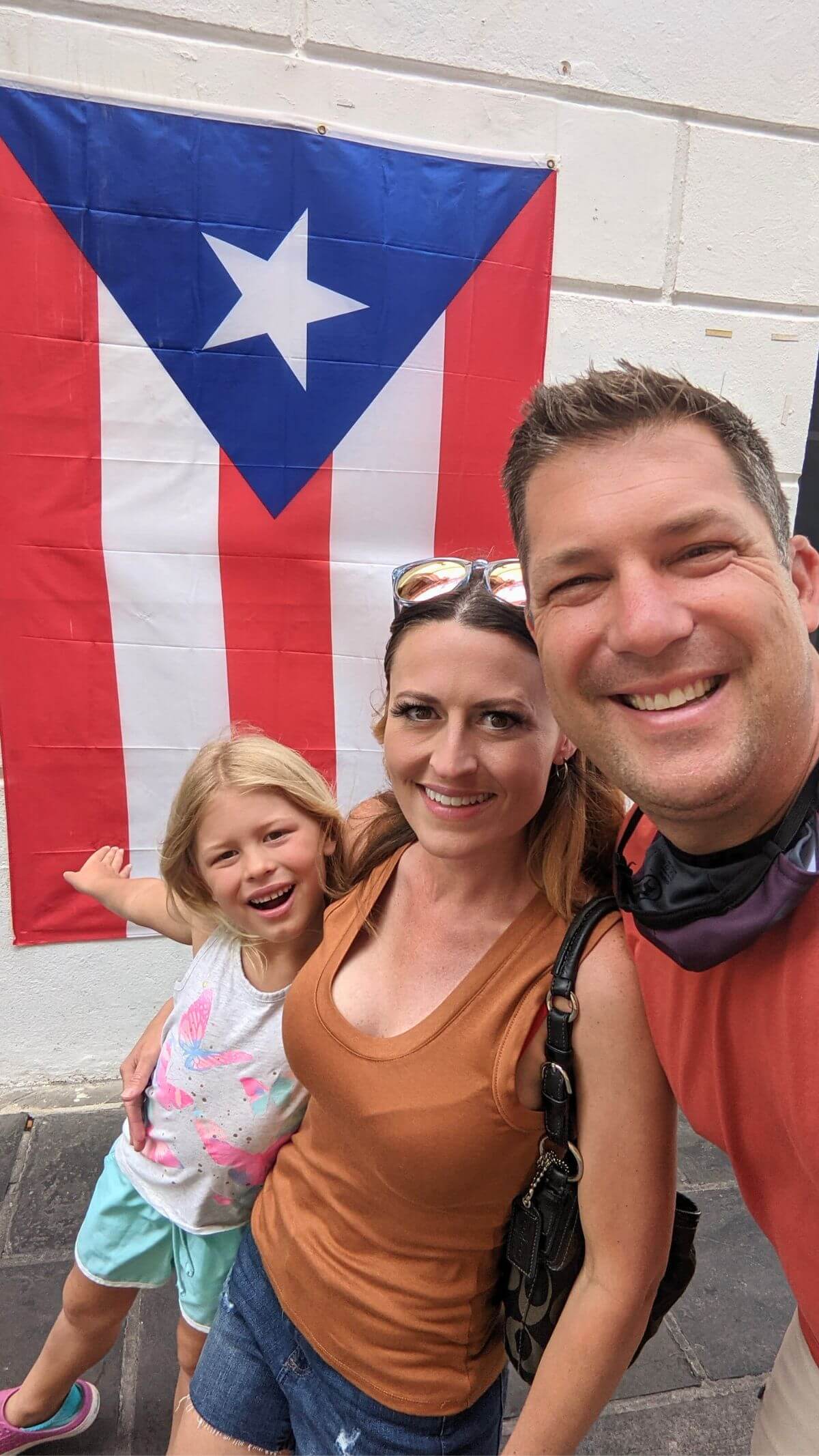 our family standing in front of the puerto rico flag