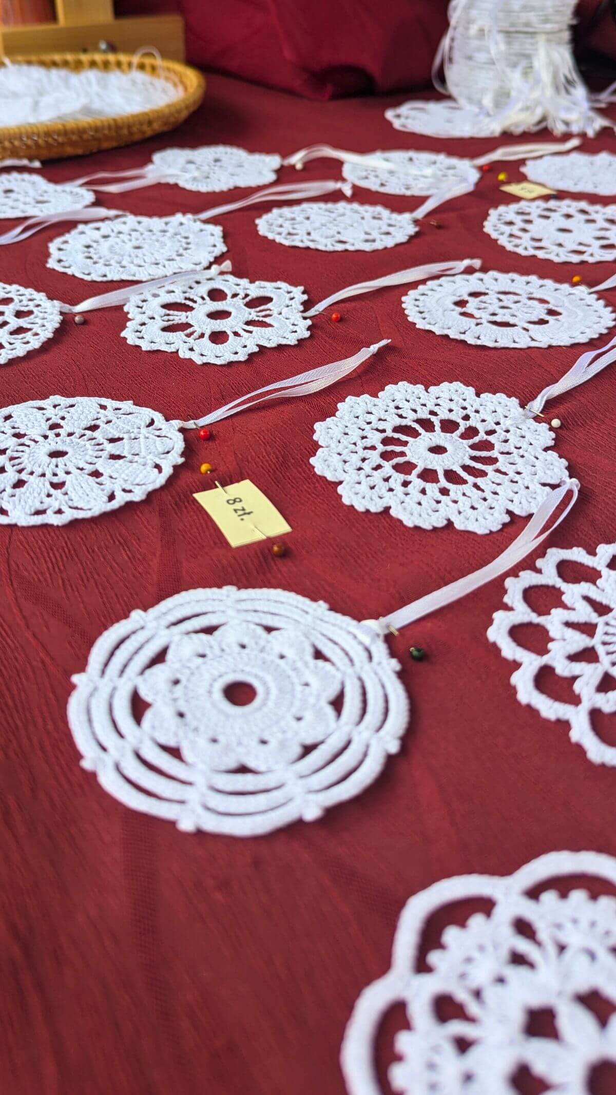 lace christmas ornaments laying on a table